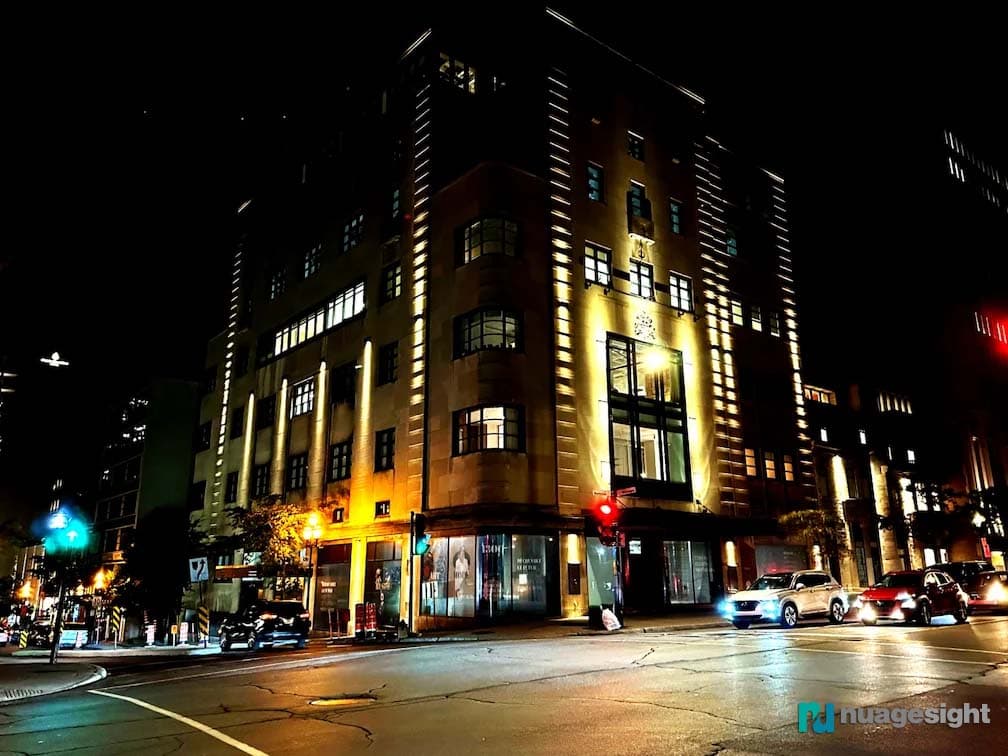 Corner view of large buildings lighting at night