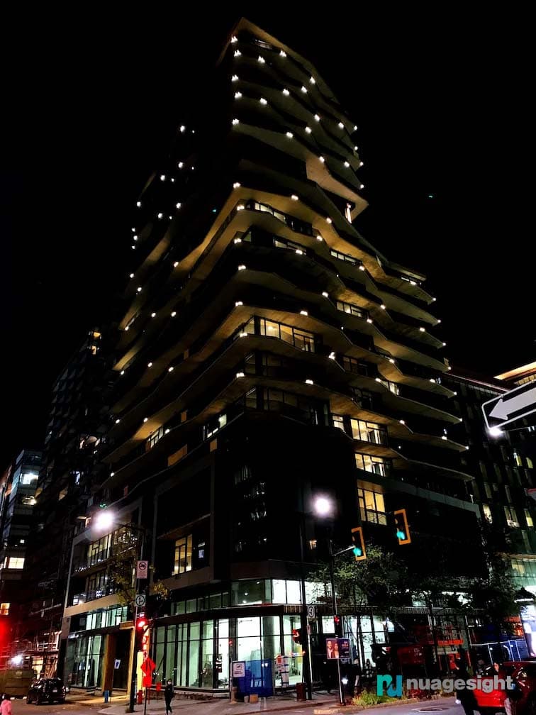 Corner view of large buildings lighting at night