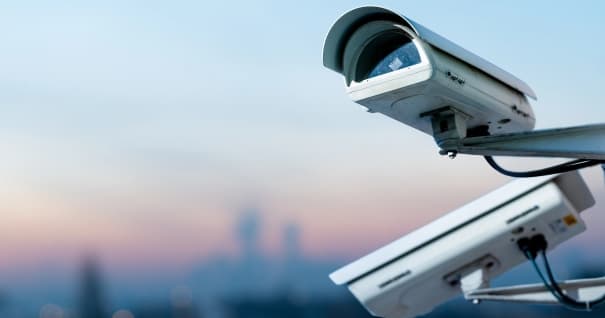 Security CCTV camera monitoring system with panoramic view of a city on blurry background