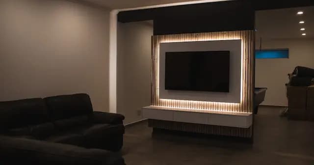Smart TV in a modern living room with a wall fixture.