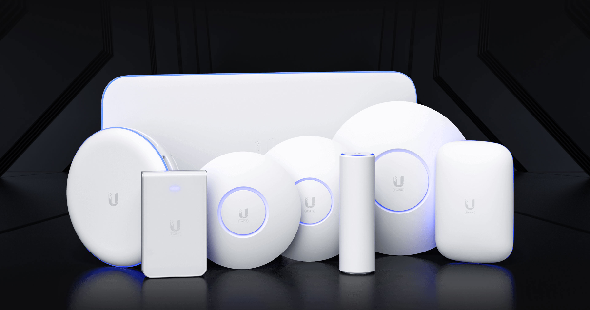 Series of Ubiquiti UniFi WiFi access points on display with black surroundings.